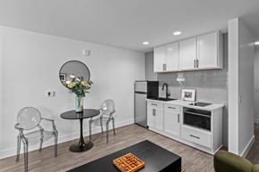 Pasco apartment for rent - a kitchen with white cabinets and a table with chairs